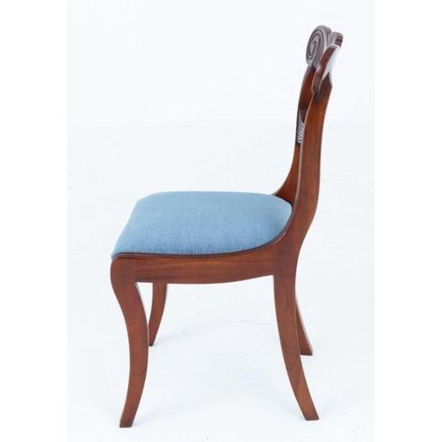 Set of 10 Regency style mahogany dining chairs These chairs feature sabre front legs and swept back legs Circa 1900 We...
