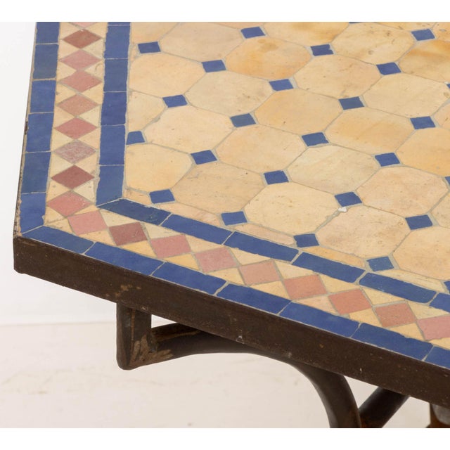 Moroccan Zellige Tile Top Hexagonal Table, the blue and pink tile top above wrought iron base on four down swept legs....