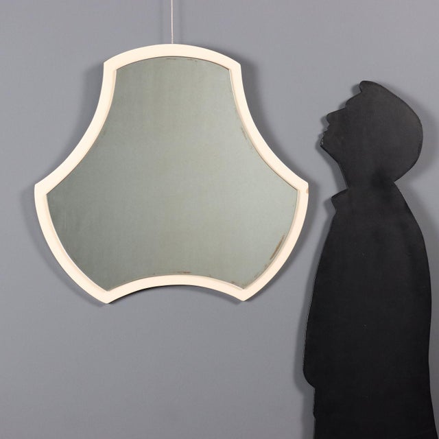 Wall mirror in lacquered wood and mirrored glass. Good condition. This piece is attributed to the mentioned...