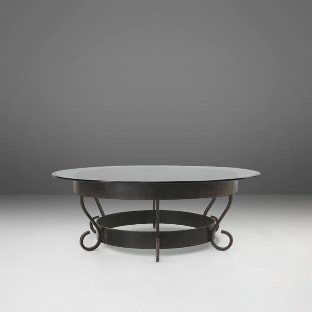 France / 1930s / wrought iron and glass / rustic / mid-century / industrial Large rustic round French coffee table with...
