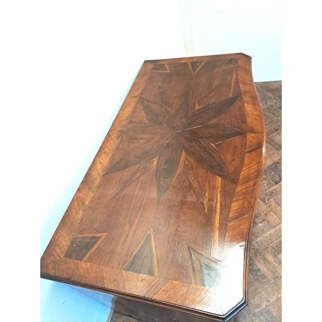 Hutton-Clarke Antiques is pleased to offer this elegant 18th century French commode, crafted in richly figured mixed...