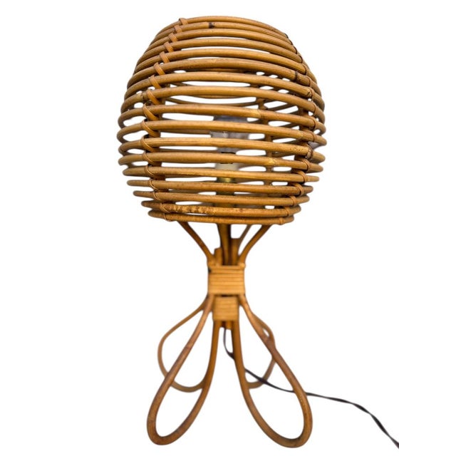 Magnificent pair of mid-century French Riviera-style table lamps, crafted from hand-woven, bent rattan and wicker. These...