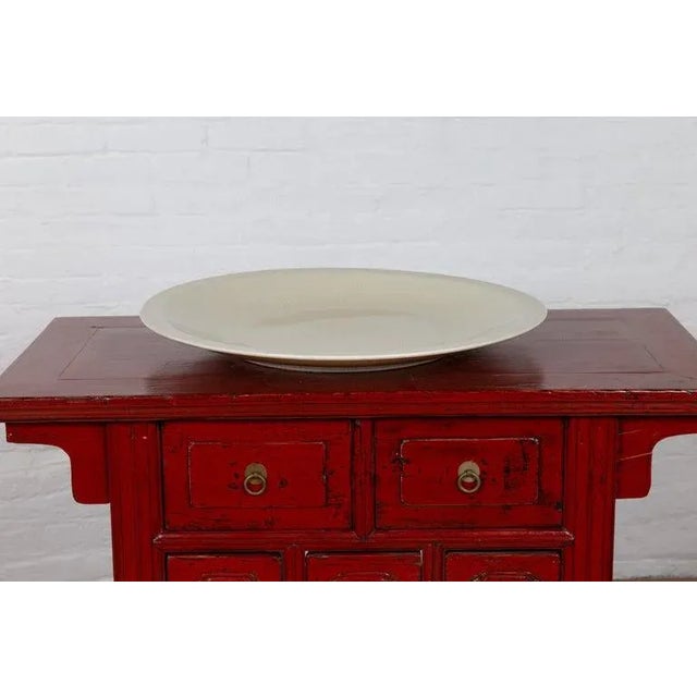 A Chinese vintage beige ceramic charger plate from the second half of the 20th century. We have two beige chargers...