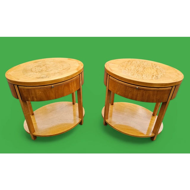 This Vintage Pair of Charles Pfister for Baker Furniture Oval nightstands beautifully combines primavera wood and stunning...