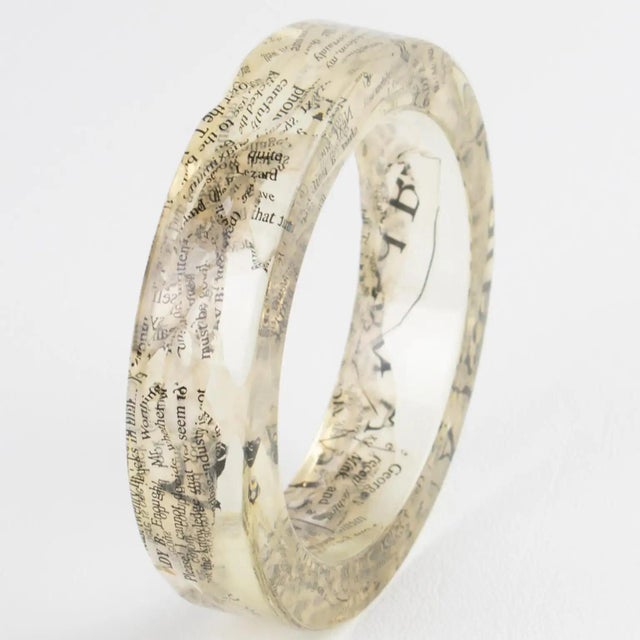 This stunning John Galliano Paris bracelet is from the 2000 Autumn-Winter "Newspaper" collection. The bangle features an...