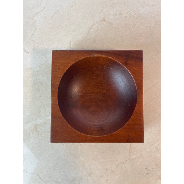 Sculptural mid-century catchall carved from a solid block of rich hardwood, likely teak, featuring a clean square...