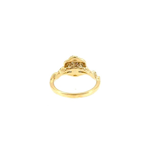 Elevate your collection with this stunning, pre-loved cushion-cut diamond halo engagement ring. Crafted in warm 14K yellow...