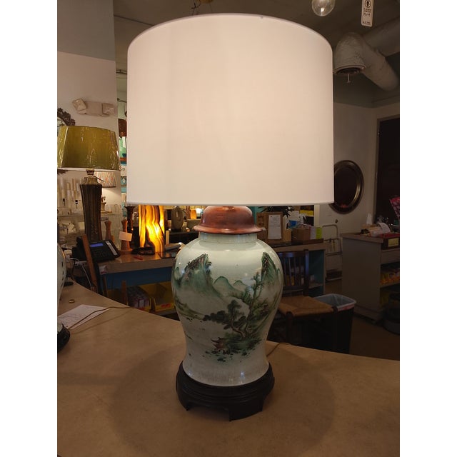 Striking oversized Asian porcelain table lamp featuring a hand-painted mountain and landscape scene in soft celadon and...