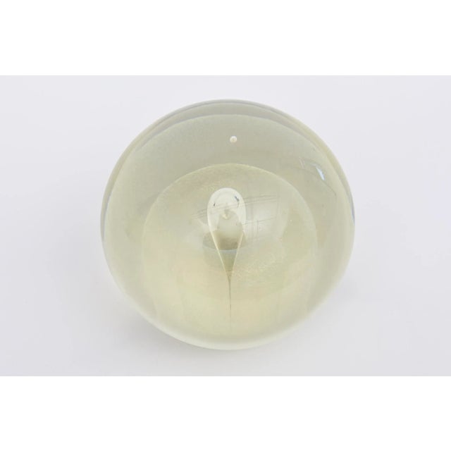 This large heavy signed vintage art glass sphere glass sculptural ball has many layers of glass submerged designs. It is...