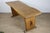 A remarkable piece from the 1950s/60s, this solid wood dining table stands out as a true sculptural work, where the...