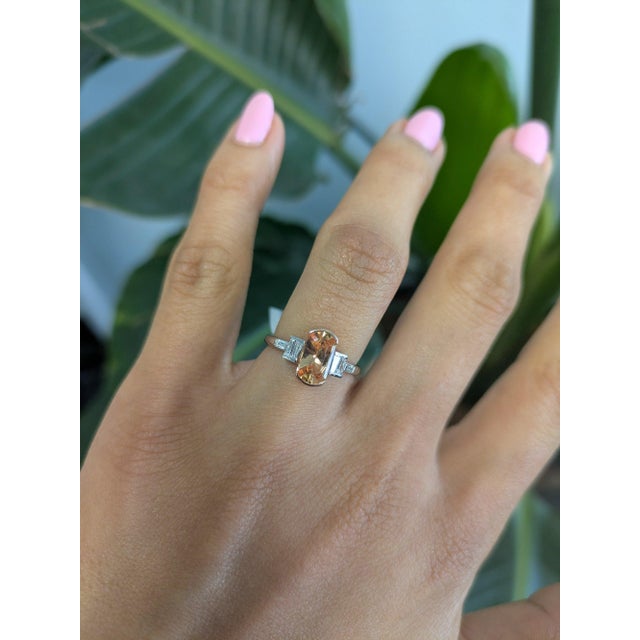 A 1.37-carat imperial topaz glows in a warm, golden-orange at the centre of this solid two-tone 14K white and rose gold...