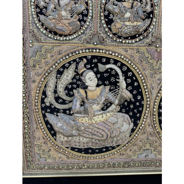 Extra-large Burmese kalaga textile, framed and ready to hang. The textile features celestial musician / apsara-style...