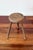 Antique tripod stool in solid wood, with a spirally turned base and a round seat marked with concentric circles, typical...