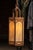 Mid-century lantern-form pendant featuring a tall hexagonal frame in a warm bronze-tone finish with translucent faux...