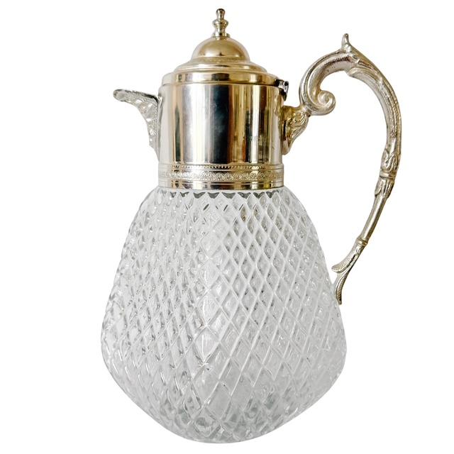 Elevate your tabletop or bar cart with this silver-plated mounted glass pitcher. Designed in a bold, bulbous silhouette,...