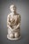 An antique alabaster sculpture depicting a kneeling female figure in the round. Lombardy, 19th century. The composition is...