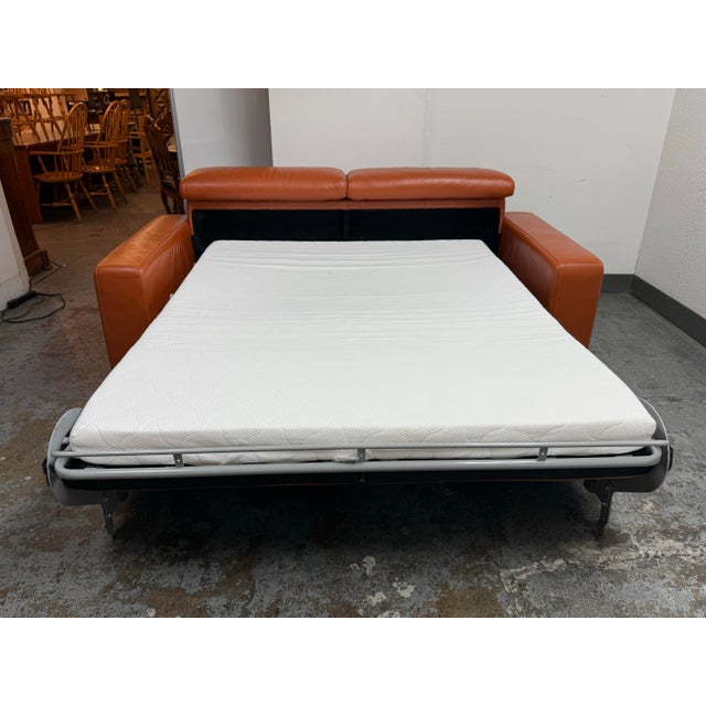 Design Plus Gallery presents an Andrew Leather Queen Sleeper Sofa in Cognac. This contemporary design showcases orange-...
