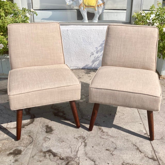 An amazing pair of Mid Century Billie Haines Style Slipper Chairs. Gorgeous Modern shape and tapered wood legs. Nice...