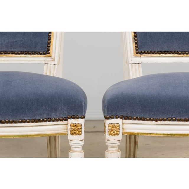 A refined pair of French Louis XVI style accent side chairs sourced in Paris, dating to the early 20th century. Each chair...