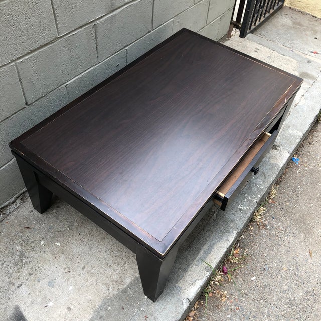 46” L x 28” W x 17.25” H Cort cocktail table with convenient and subtle drawer for storage. From the Godiva line, in...