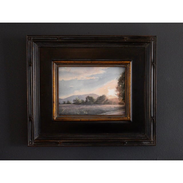 The artwork captures a tranquil summer landscape at dusk, where soft hues of orange and purple blend seamlessly in the sky...