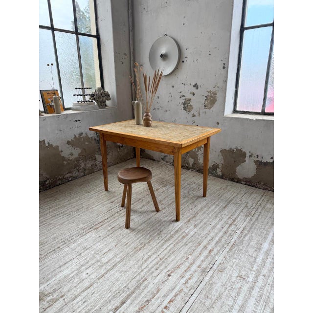 Table from the 60s, with its solid oak spindle legs, and its oak top surround, framing a Scandinavian ceramic tile top,...