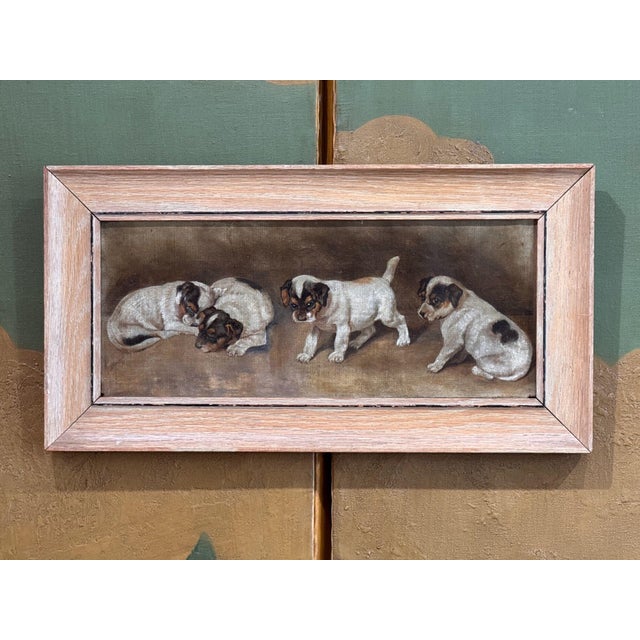 American School oil on canvas of four Jack Russell Terrier puppies. Two are curled up asleep together, one steps forward...
