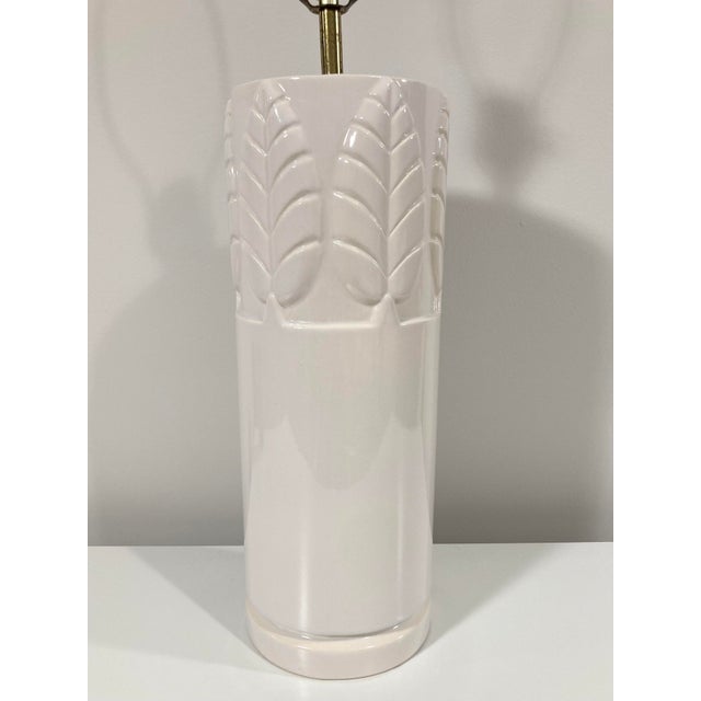 This vintage ceramic lamp features a simple bird of paradise leaf bas-relief pattern encircling the top. Likely produced...