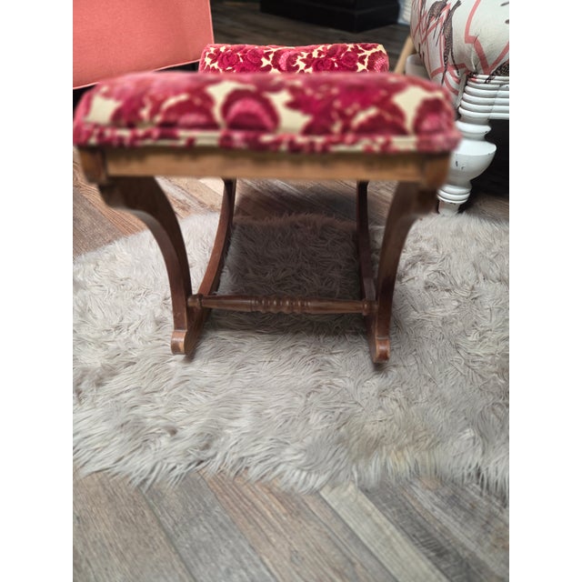 Design: This specific piece features a curved wooden frame on rockers and an upholstered, cushioned top.Upholstery: It is...