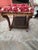 Design: This specific piece features a curved wooden frame on rockers and an upholstered, cushioned top.Upholstery: It is...