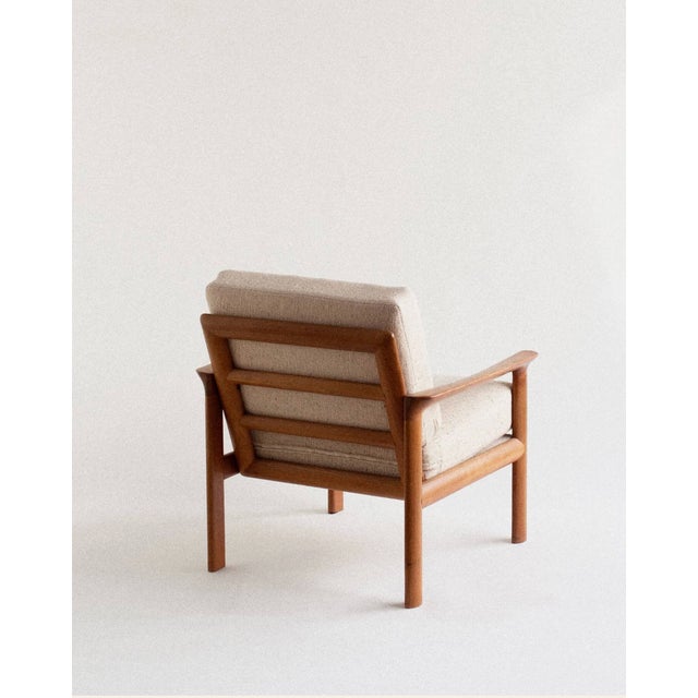A set of lounge chairs designed by Arne Wahl Iversen for Komfort, defined by a solid teak frame and the clean, confident...