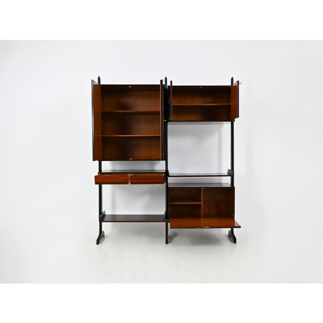 A bookcase consisting of one box with a drop-down door containing a shelf, one box with two drawers, one box with two...