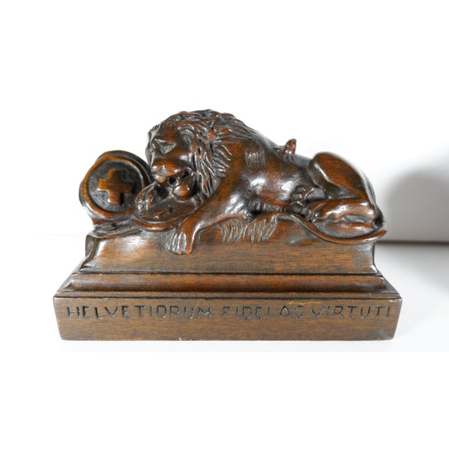 A vintage pair of carved mahogany bookends depicting the Lions of Lucerne. Danish sculptor Bertel Thorvaldsen designed the...