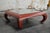 Chinoiserie Ming style Coffee Table in Chinese red. Table features curved scroll legs with a custom vintaged mirror top....