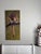 This oil painting depicts a poised mountain lion, its intense gaze focused intently as it crouches on a branch, ready to...