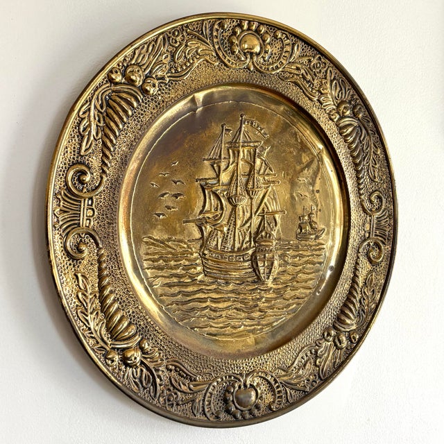Vintage English brass repousse decorative plate. A lovely object as a standalone or to add to a collection in a Nautical...