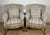 Elegant pair of armchairs in Louis XV style, featuring gracefully curved silhouettes and carved giltwood bases with...