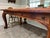 Beautiful substantial solid mesquite wood dining table featuring beautifully carved legs and a warm, richly grained...