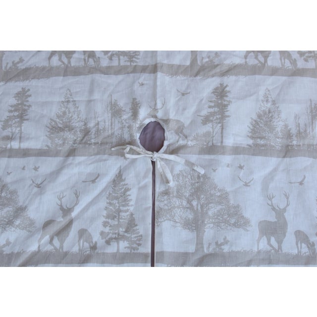 Custom-tailored Christmas tree skirt made from linen fabric printed with a woodland motif. Off-white cotton fabric...