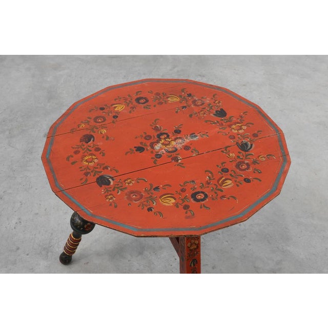 A vibrant and characterful early‑19th‑century Hindeloopen side table from the northern Netherlands, showcasing the richly...