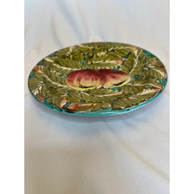 Colorful vintage plate featuring apples and leaves in rich reds and greens. This plate is signed Styson Italy. 8.5” in...