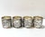 A striking set of four silverplate napkin rings featuring high-relief lion’s head motifs framed by scrolling acanthus...