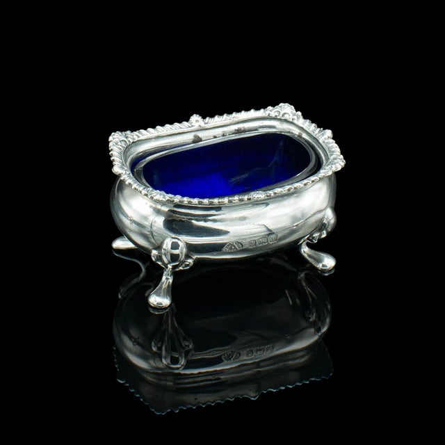 This is a vintage cased condiment set. An English, Sterling silver and cobalt glass tableware case, dating to the mid 20th...