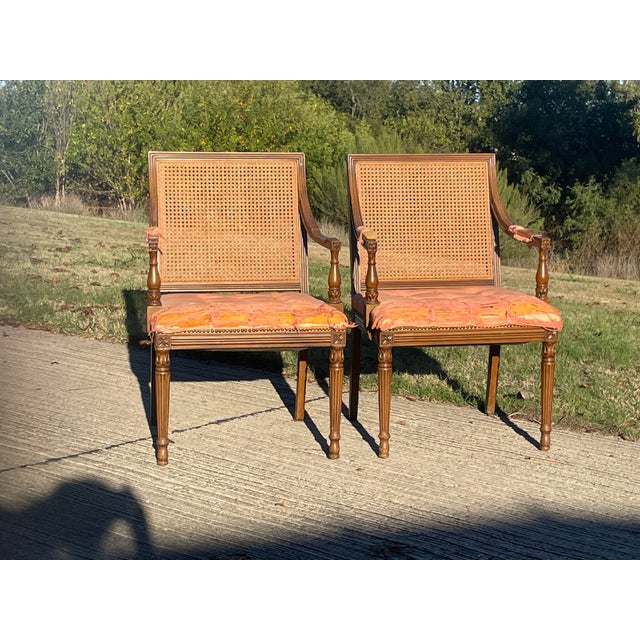 Louis XVI Style Chairs - A Pair. Cane back arm chairs with excellent details.