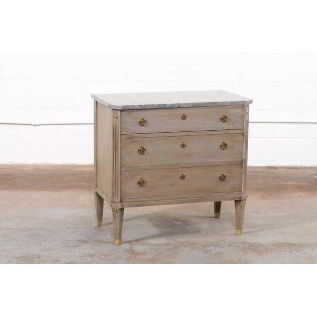A Swedish Gustavian-style chest, with original gray marble top and brass hardware, from the mid-20th century. This mid-...