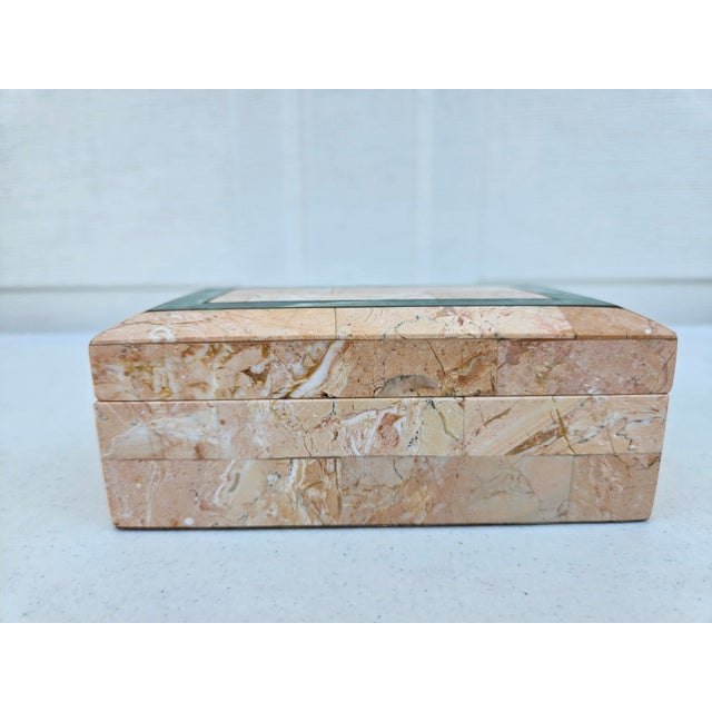 A beautiful, tessellated stone trinket box in a peach color with green highlights on the top, along with brass accent...
