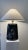 Beautiful, tall and elegant black ceramic Art Deco table lamp with shade. Featuring white lilies Cascading down the front...