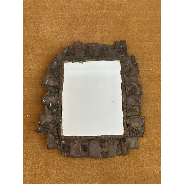 Unique brutalist brass torch-cut wall mirror with engraved motifs. Sourced in Paris.