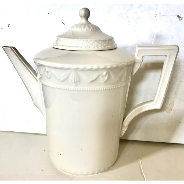 This German KPM Berlin Kurland “Blanc Nouveau" white porcelain coffee/tea set features a classicist relief design in a...