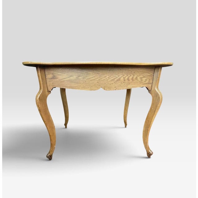 Streamlined accent table with a hint of whimsical features. Constructed in a Birds Eye maple wood. The tables scalloped...